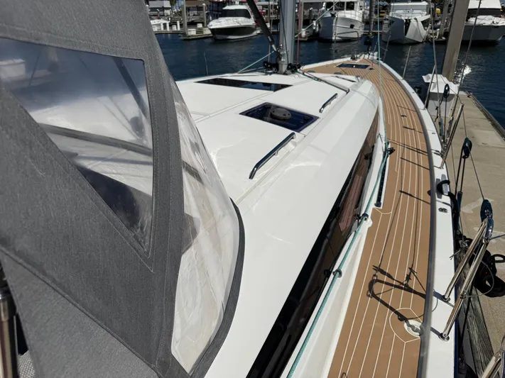  Yacht Photos Pics 2021 Jeanneau 51 sailboat docked, showcasing sleek deck design and marina background.