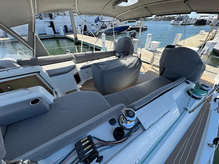  Yacht Photos Pics Jeanneau 51 yacht cockpit, 2021 model, featuring covered seating and marina view.