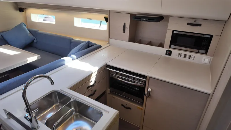 Yacht Photos Pics Modern kitchen interior of 2021 Jeanneau 51 yacht with sleek design and appliances.