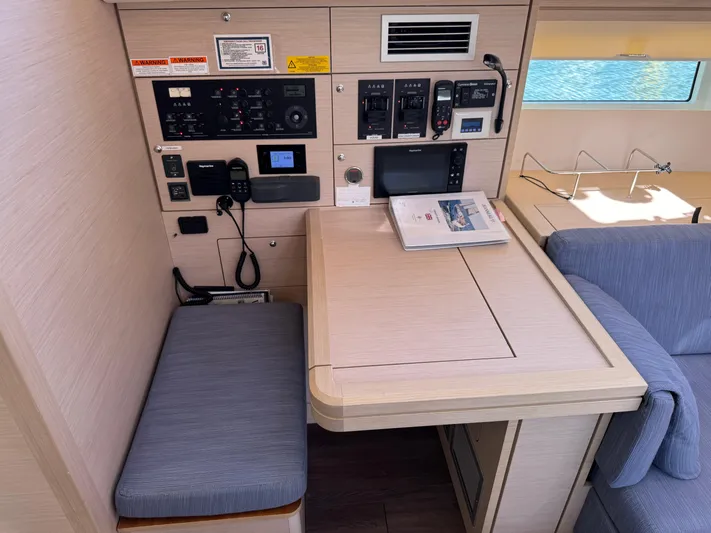  Yacht Photos Pics Navigation station inside 2021 Jeanneau 51 yacht, featuring control panels and seating.