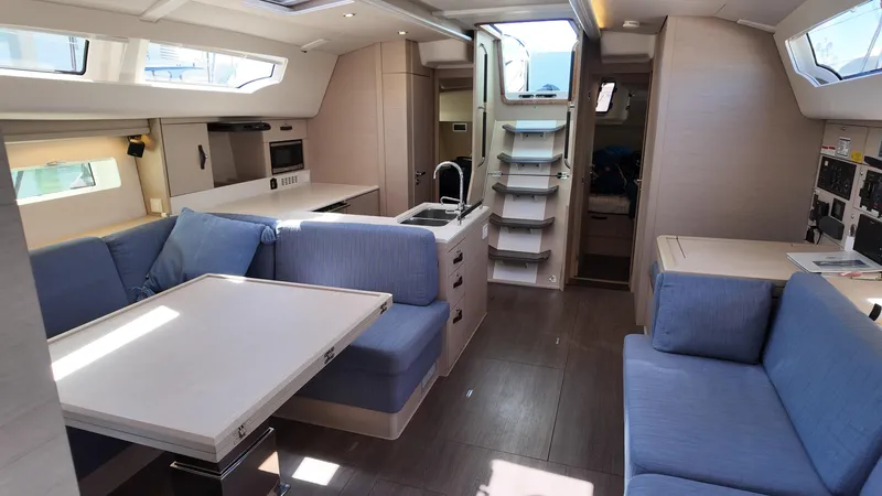  Yacht Photos Pics Modern interior of a 2021 Jeanneau 51 yacht with spacious seating and sleek design.
