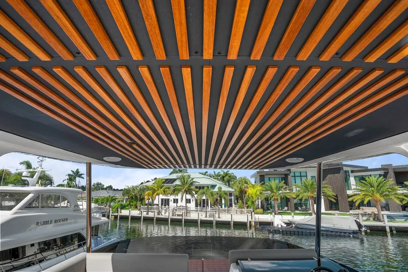 My Way Yacht Photos Pics Astondoa AS5 2023 yacht with stylish wooden ceiling, docked near luxury waterfront homes.