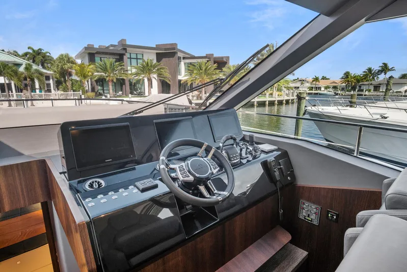 My Way Yacht Photos Pics 2023 Astondoa AS5 yacht helm with modern controls, docked near luxury waterfront homes.
