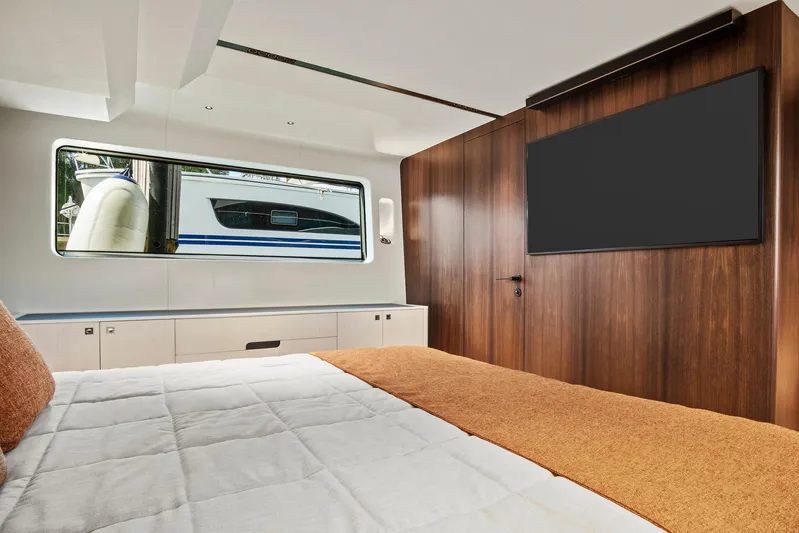 My Way Yacht Photos Pics Luxurious 2023 Astondoa AS5 yacht bedroom with modern wood paneling and large window.