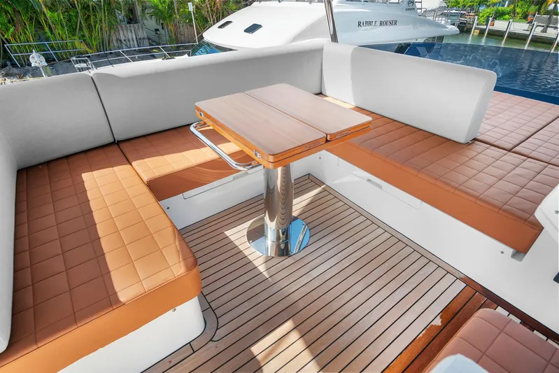 My Way Yacht Photos Pics Luxurious seating area on 2023 Astondoa AS5 yacht with teak flooring and cushioned benches.