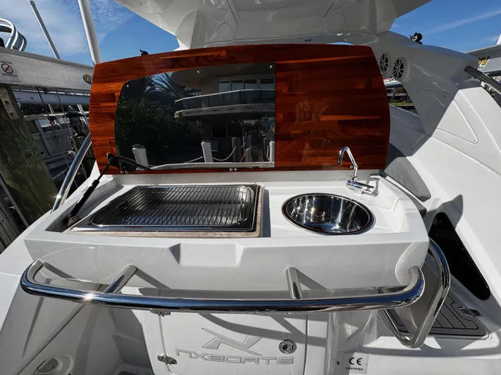  Yacht Photos Pics 2024 NX Boats 280 Xtreme outdoor kitchen with sink and grill.