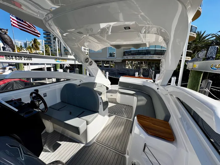  Yacht Photos Pics 2024 NX Boats 280 Xtreme interior with sleek seating and modern design in a marina setting.