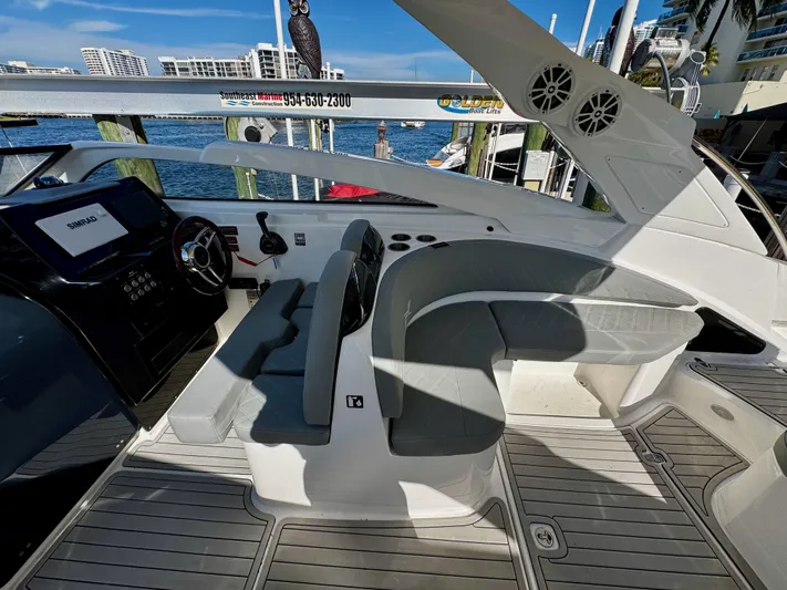  Yacht Photos Pics 2024 NX Boats 280 Xtreme cockpit with modern seating and controls, docked by the water.