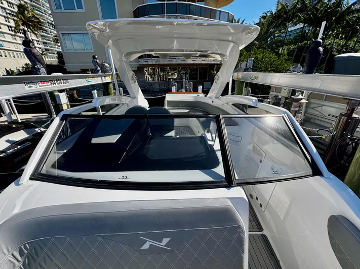  Yacht Photos Pics 2024 NX Boats 280 Xtreme docked, showcasing sleek design and modern features.