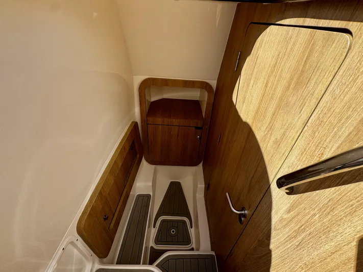  Yacht Photos Pics 2024 NX Boats 280 Xtreme cabin interior with wood finish and modern design.