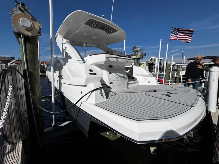  Yacht Photos Pics 2024 NX Boats 280 Xtreme docked, showcasing sleek design and spacious deck.