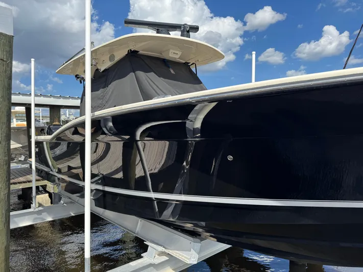  Yacht Photos Pics 2021 Scout 330 LXF boat docked under a clear blue sky.