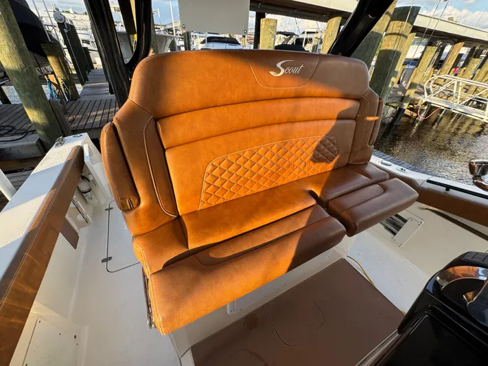 Yacht Photos Pics Luxurious brown leather seating on a 2021 Scout 330 LXF boat at a marina.