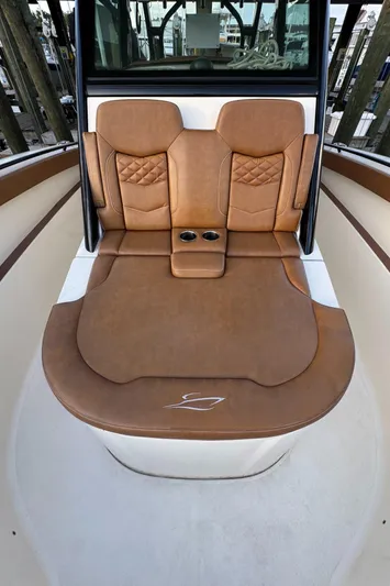  Yacht Photos Pics 2021 Scout 330 LXF boat interior with luxurious brown leather seating and cup holders.