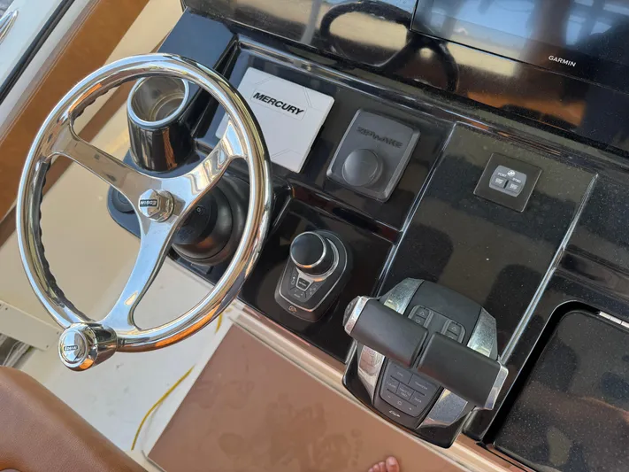  Yacht Photos Pics 2021 Scout 330 LXF boat dashboard with steering wheel and controls.