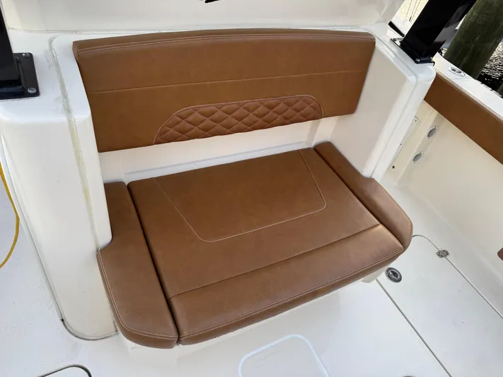  Yacht Photos Pics Brown leather seat on 2021 Scout 330 LXF boat, featuring diamond stitching.