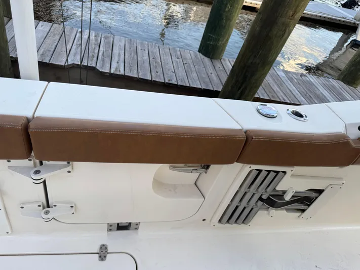  Yacht Photos Pics 2021 Scout 330 LXF boat interior with brown seating and dock view.