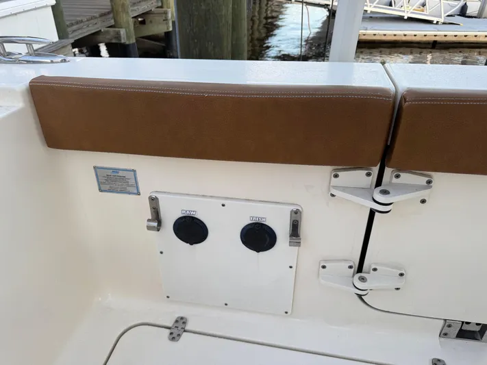  Yacht Photos Pics 2021 Scout 330 LXF boat interior with brown seating and utility panel.