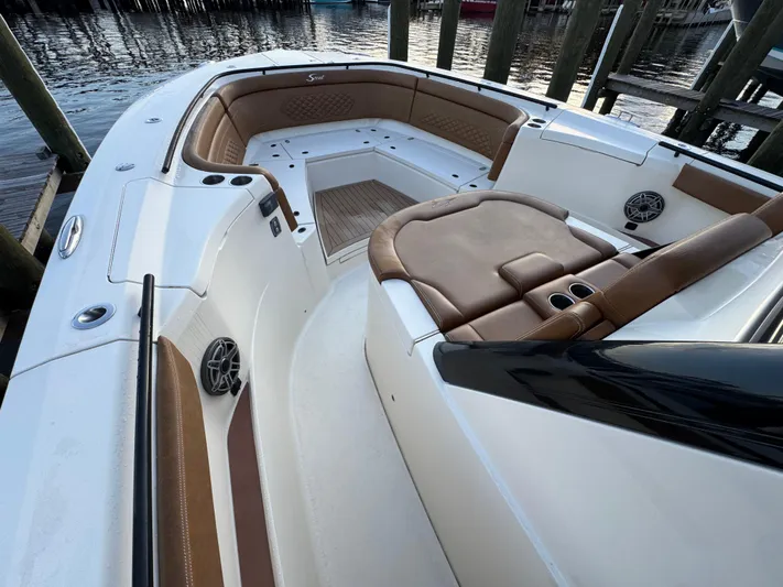  Yacht Photos Pics 2021 Scout 330 LXF boat interior with luxurious seating and cup holders.