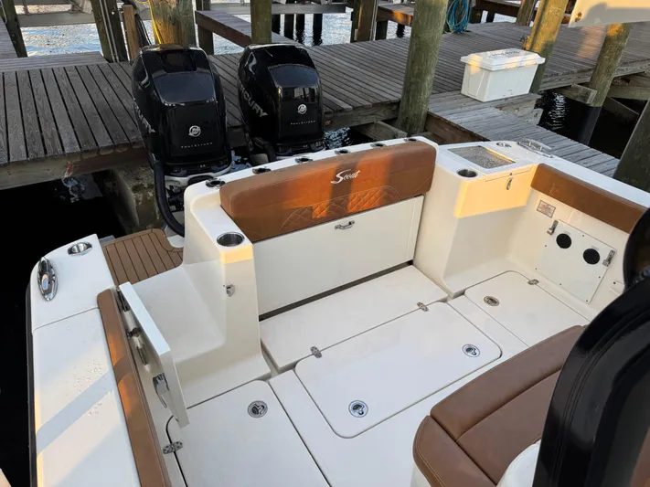  Yacht Photos Pics 2021 Scout 330 LXF boat interior with dual Mercury engines at dock.