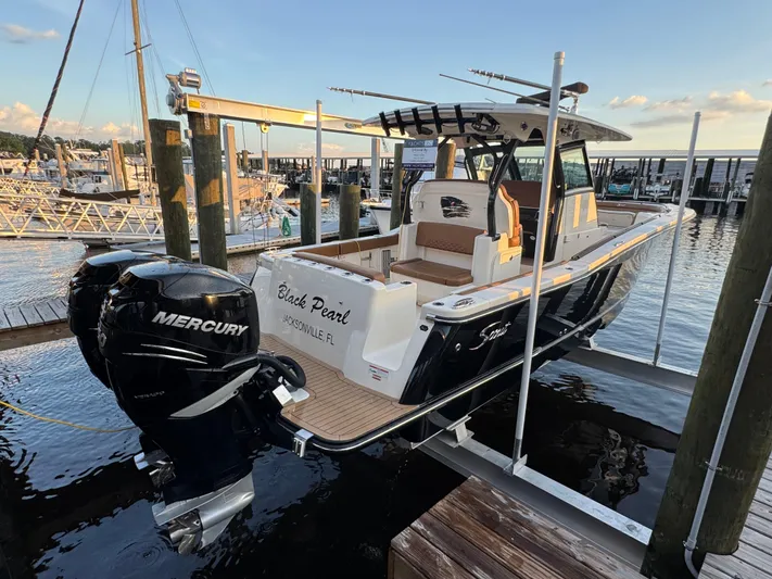  Yacht Photos Pics 2021 Scout 330 LXF boat docked, featuring dual Mercury engines, named "Black Pearl" in Jacksonville, FL.