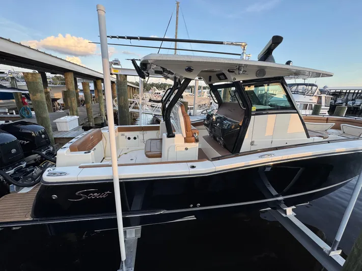 Yacht Photos Pics 2021 Scout 330 LXF boat docked, featuring sleek design and modern amenities.