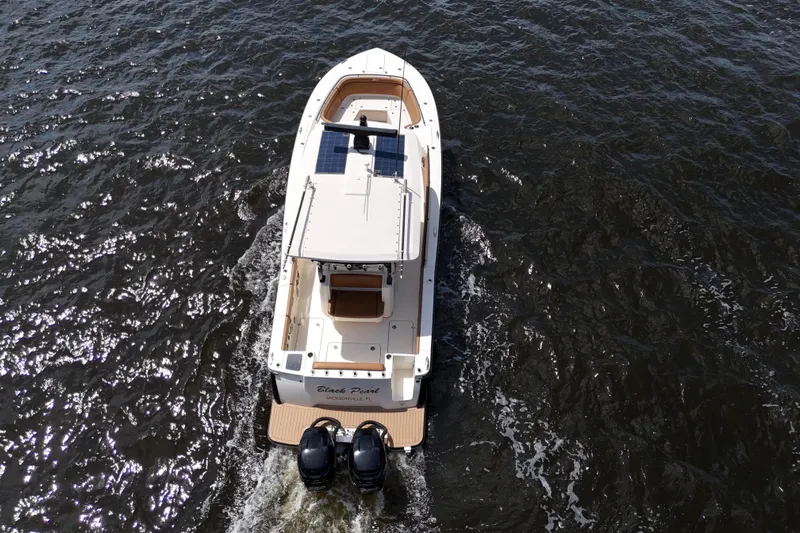  Yacht Photos Pics 2021 Scout 330 LXF boat cruising on open water, aerial view.