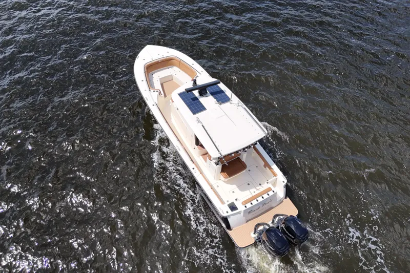  Yacht Photos Pics 2021 Scout 330 LXF boat cruising on open water, aerial view.