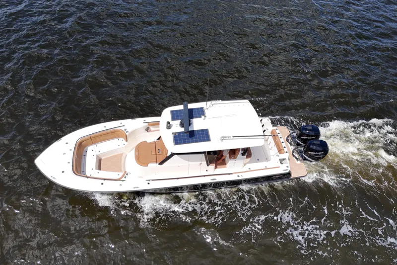  Yacht Photos Pics 2021 Scout 330 LXF boat cruising on water, aerial view.