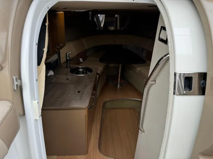  Yacht Photos Pics Interior of a 2013 Formula 350 Sun Sport boat, featuring a cozy cabin and kitchenette.