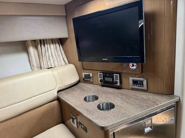  Yacht Photos Pics Interior of 2013 Formula 350 Sun Sport with TV, beige seating, and countertop.