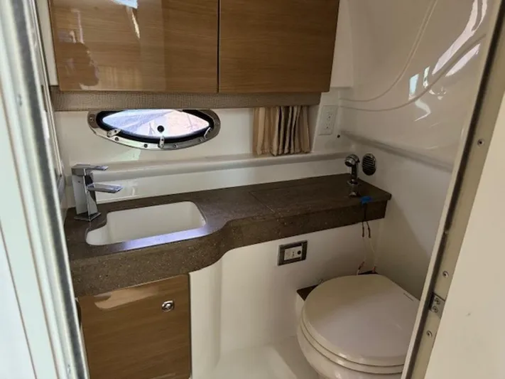  Yacht Photos Pics 2013 Formula 350 Sun Sport bathroom with sink, toilet, and wooden cabinetry.