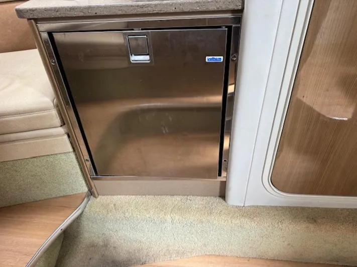  Yacht Photos Pics 2013 Formula 350 Sun Sport interior with stainless steel mini fridge and wooden cabinetry.