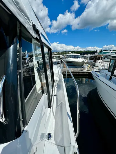 Pearl Yacht Photos Pics 2024 Jeanneau NC 895 docked at marina under blue sky.