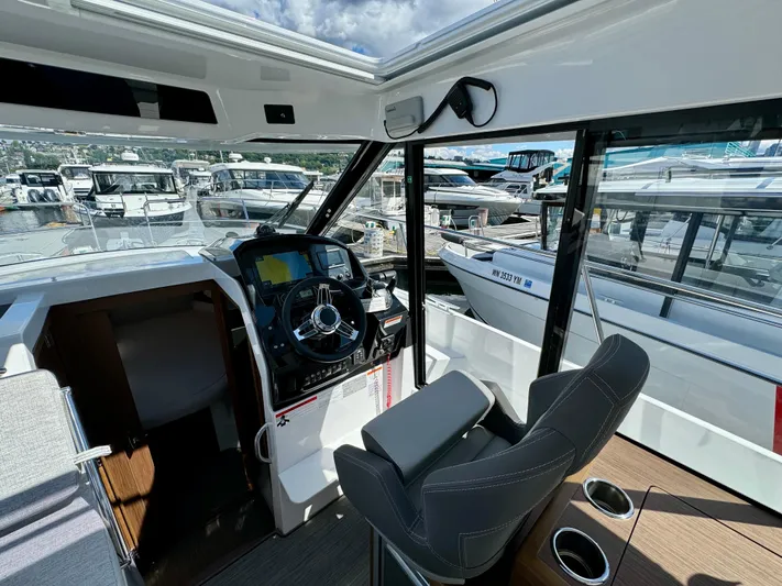 Pearl Yacht Photos Pics 2024 Jeanneau NC 895 helm with modern controls, docked at marina.