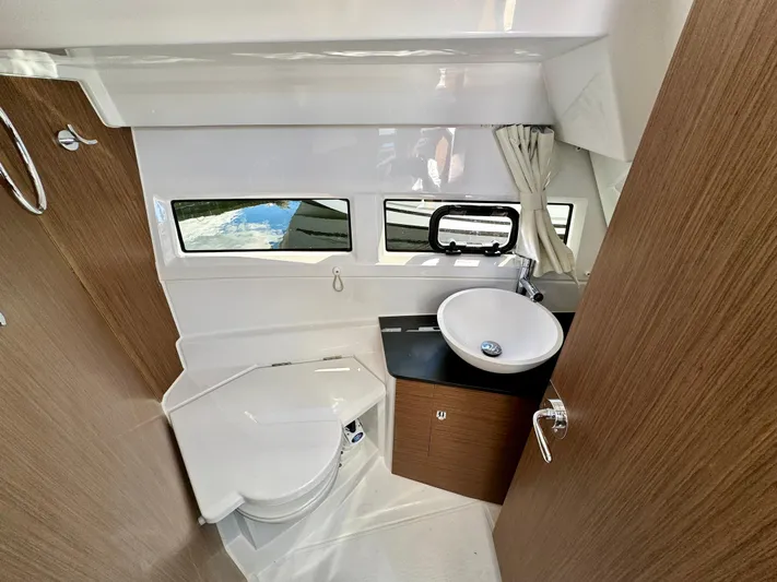 Pearl Yacht Photos Pics 2024 Jeanneau NC 895 bathroom with modern sink, toilet, and wood accents.