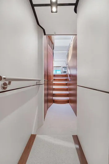  Yacht Photos Pics Interior hallway of 2021 Princess Y78 yacht with wooden stairs and modern design.