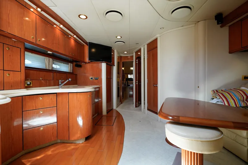  Yacht Photos Pics Luxurious interior of 2000 Sea Ray 510 Sundancer yacht with wood cabinetry and modern amenities.