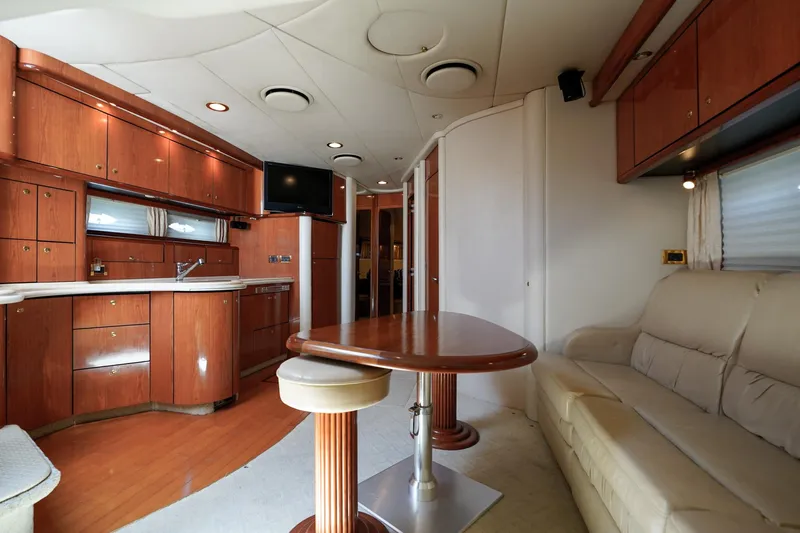  Yacht Photos Pics Luxurious interior of 2000 Sea Ray 510 Sundancer yacht with wood cabinetry and plush seating.