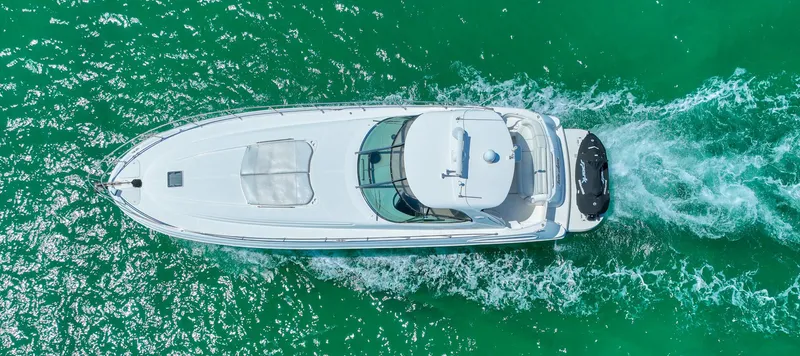  Yacht Photos Pics Aerial view of 2000 Sea Ray 510 Sundancer cruising on turquoise water.