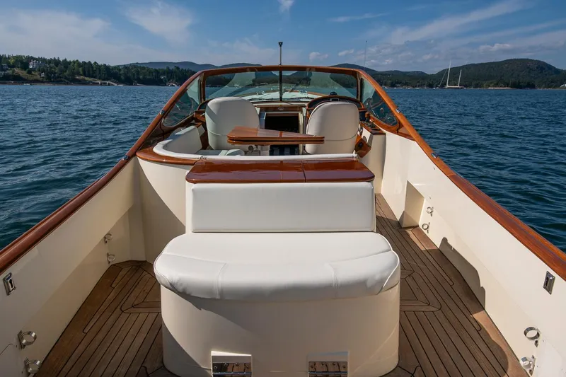 Pappy Yacht Photos Pics 2004 Hinckley Talaria 29 Runabout on serene water, showcasing elegant wooden and white seating.