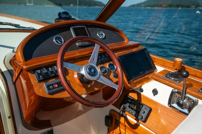 Pappy Yacht Photos Pics 2004 Hinckley Talaria 29 Runabout dashboard with wooden steering wheel and navigation controls.