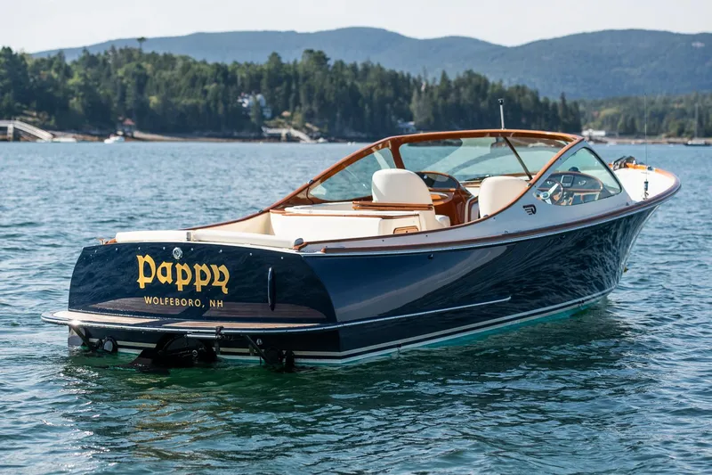 Pappy Yacht Photos Pics 2004 Hinckley Talaria 29 Runabout on scenic lake with forested hills in background.