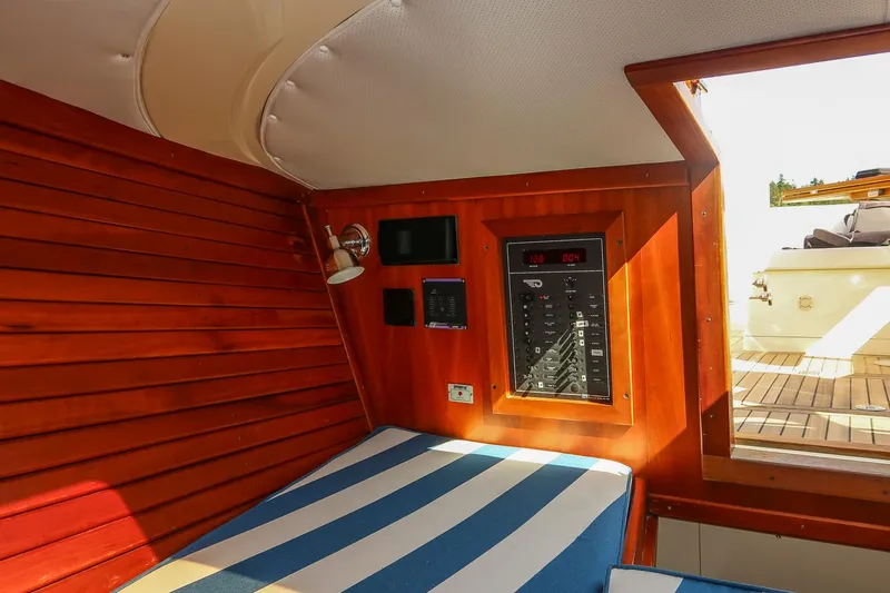 Pappy Yacht Photos Pics Interior of 2004 Hinckley Talaria 29 Runabout with striped seating and wooden paneling.