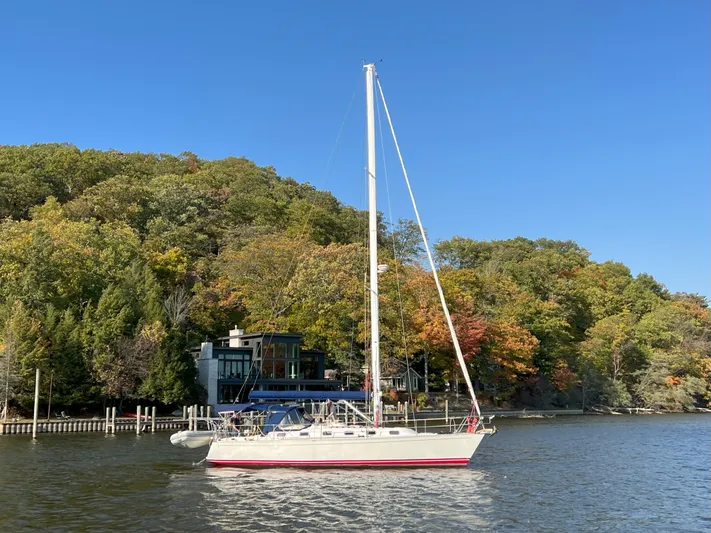 Nino Yacht Photos Pics Sailboat Tartan 4100 (2007) on a serene lake with autumn trees in the background.