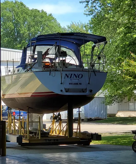 Nino Yacht Photos Pics Sailboat "Nino" on trailer, Tartan 4100 model, 2007, in Holland, MI, surrounded by trees.