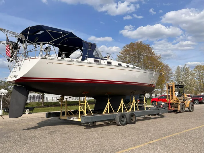 Nino Yacht Photos Pics Tartan 4100 sailboat from 2007 on trailer, parked outdoors under blue sky.