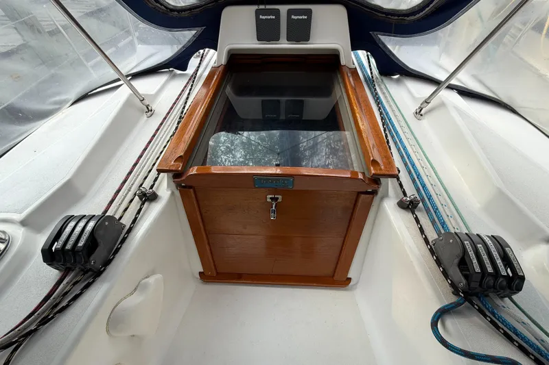 Nino Yacht Photos Pics Cabin entrance of 2007 Tartan 4100 sailboat with wooden hatch and control lines.