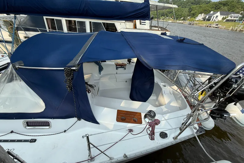Nino Yacht Photos Pics 2007 Tartan 4100 sailboat with blue canopy docked at a marina.