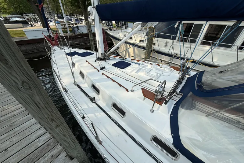 Nino Yacht Photos Pics Sailboat docked at marina, Tartan 4100 model, 2007, with blue accents and wooden details.